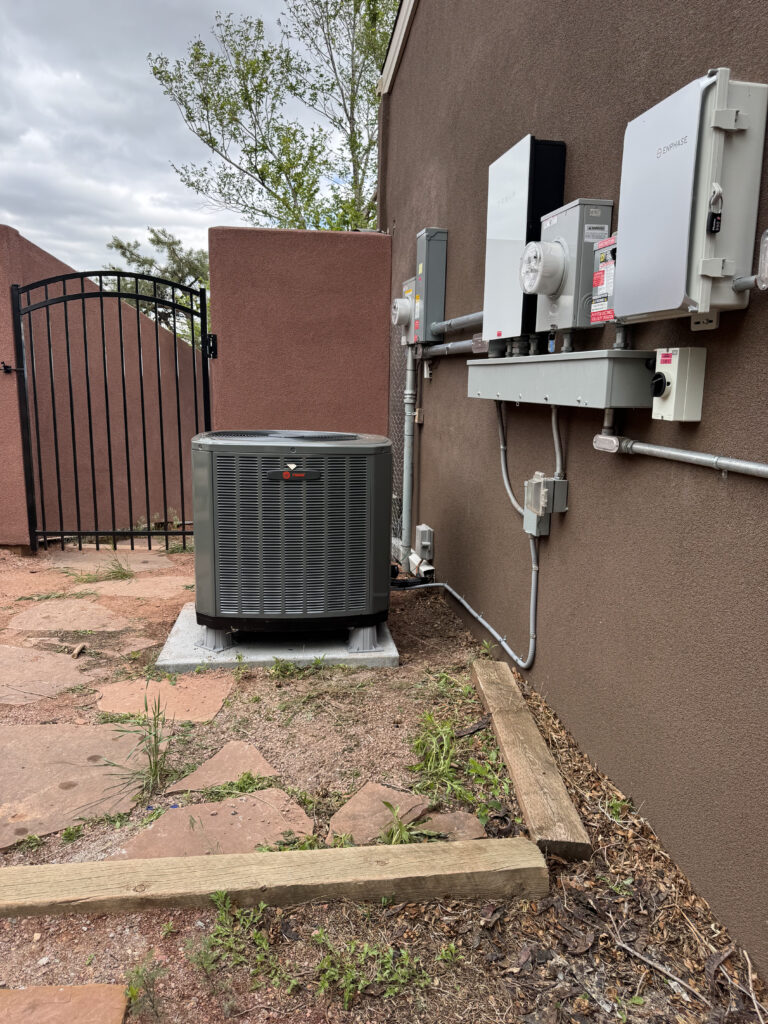 Homeowner discussing new air conditioning system installation with an HVAC professional for better comfort and efficiency